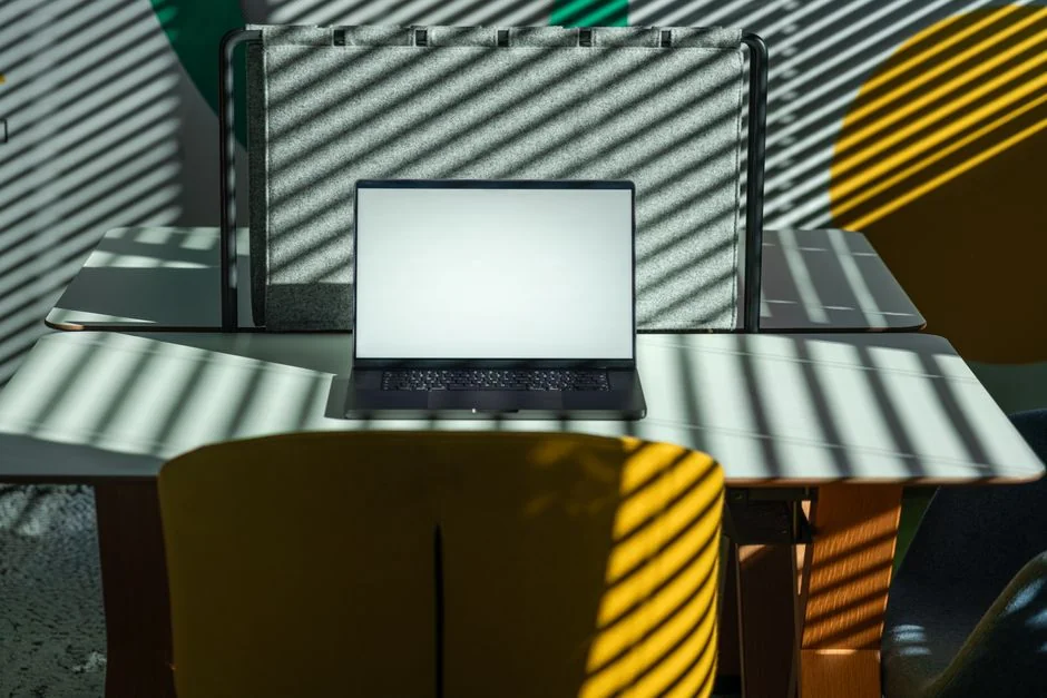 A modern workspace featuring dual computer monitors displaying web design projects, emphasizing technology and productivity.